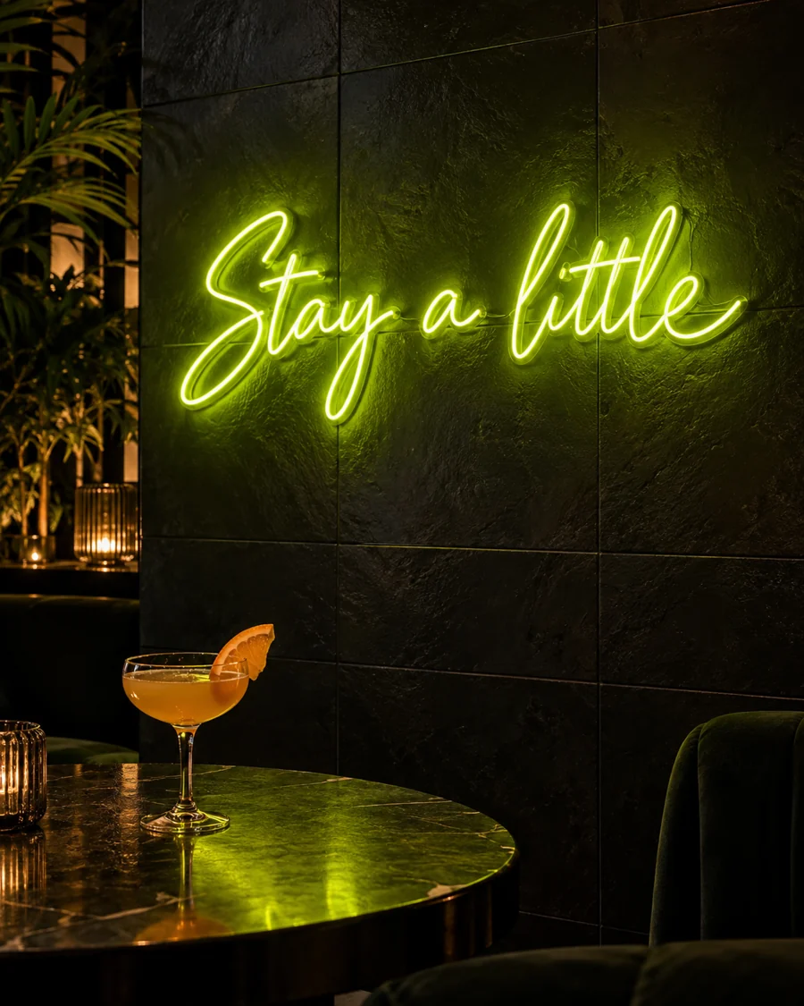 Illustrative lounge concept with a lime Stay a little neon sign