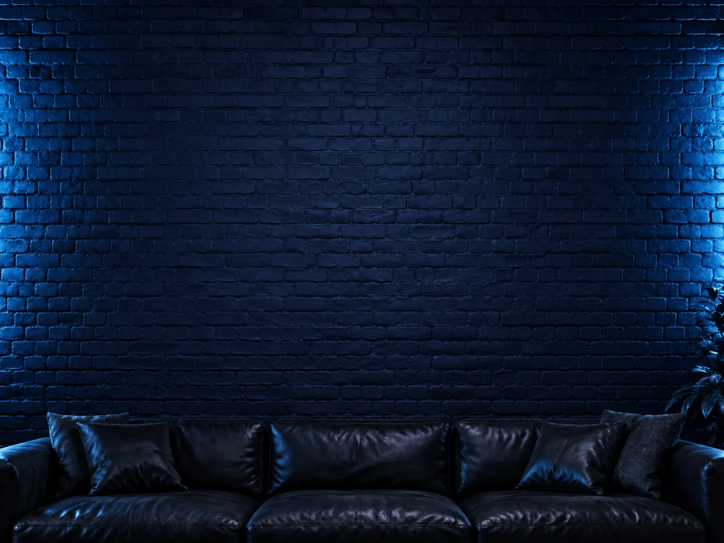 Navy blue brick studio wall with a black sofa